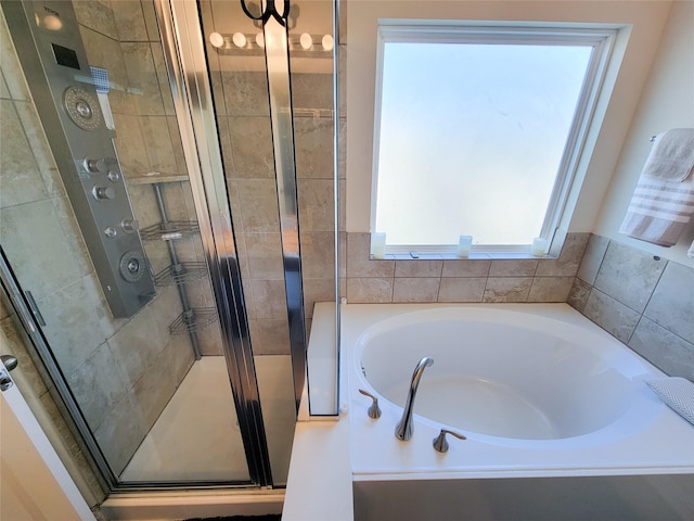 bathroom featuring separate shower and tub