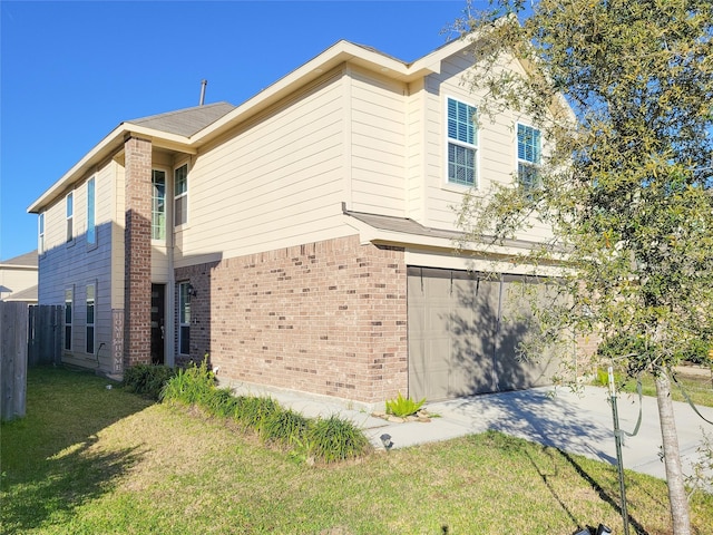 view of side of property with a lawn and a garage