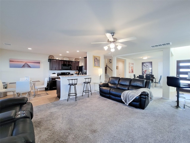 living room featuring ceiling fan and light carpet