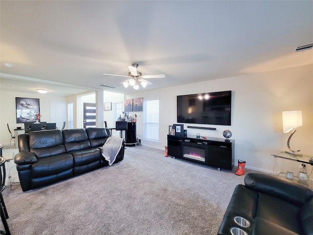 carpeted living room featuring ceiling fan