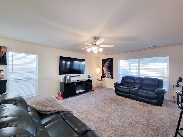 carpeted living room featuring ceiling fan