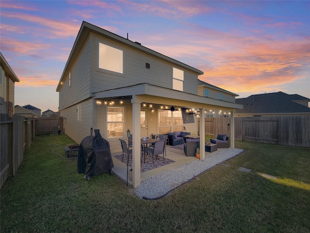 back house at dusk with a lawn, an outdoor hangout area, central air condition unit, and a patio area