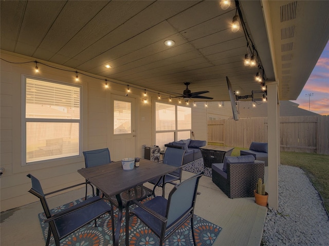 patio terrace at dusk with ceiling fan and outdoor lounge area