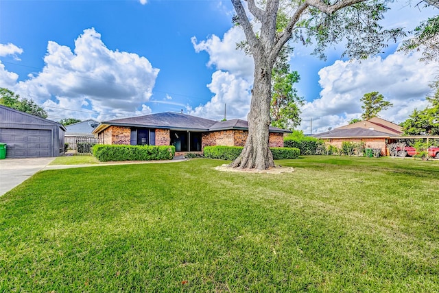 view of front of house featuring a garage, an outdoor structure, and a front yard