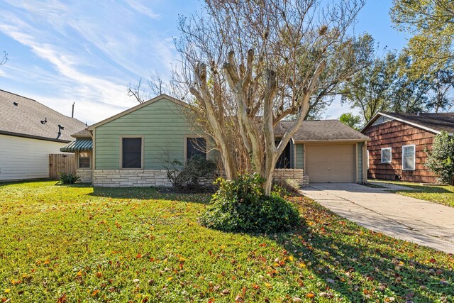 single story home with a front yard and a garage