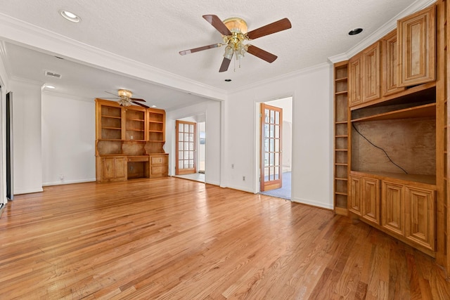 unfurnished living room with ceiling fan, light hardwood / wood-style floors, a textured ceiling, and ornamental molding