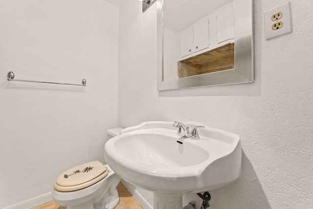 bathroom with toilet and sink