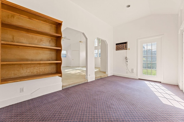 foyer with ceiling fan, light carpet, and vaulted ceiling