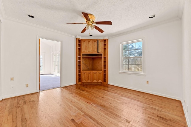 unfurnished bedroom with ceiling fan, light hardwood / wood-style floors, ornamental molding, and a textured ceiling