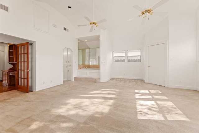 unfurnished room featuring ceiling fan, light carpet, and high vaulted ceiling