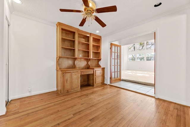 unfurnished office with french doors, light hardwood / wood-style floors, ceiling fan, and crown molding