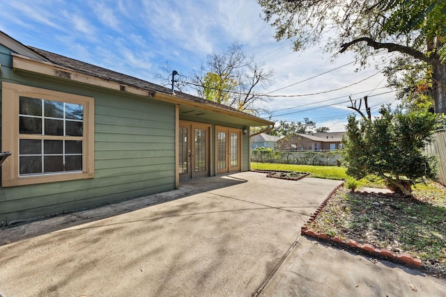 view of side of home featuring french doors and a patio