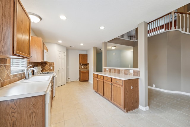 kitchen with white appliances, sink, and tasteful backsplash