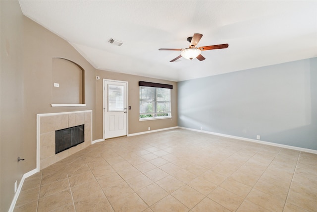 unfurnished living room featuring ceiling fan, light tile patterned flooring, and a fireplace