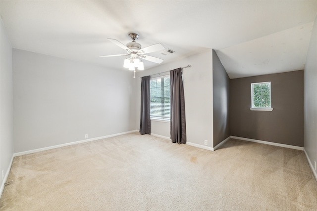 interior space featuring light carpet, ceiling fan, and lofted ceiling