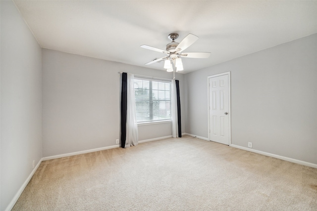 empty room with light colored carpet and ceiling fan