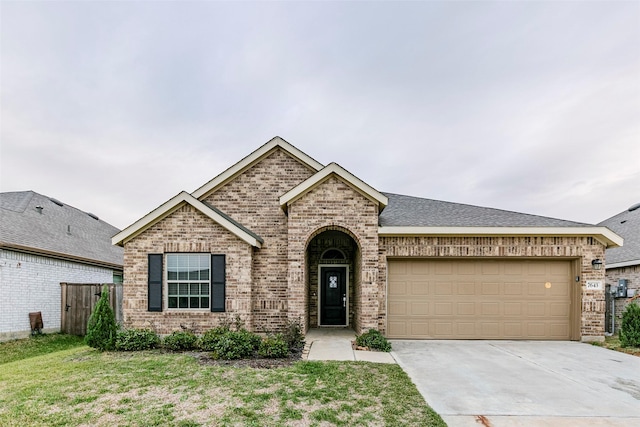 view of front of property with a garage and a front lawn