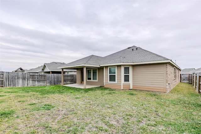 rear view of house with a yard and a patio