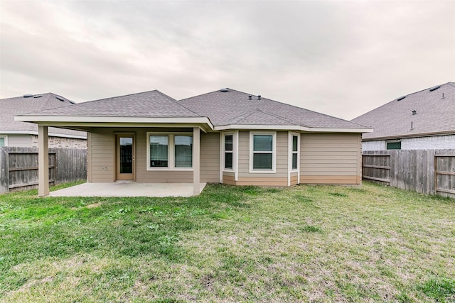 back of property with a patio area and a lawn