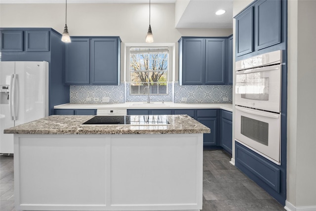 kitchen featuring white appliances, blue cabinets, sink, hanging light fixtures, and a kitchen island