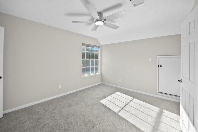 unfurnished room featuring ceiling fan, light carpet, and vaulted ceiling