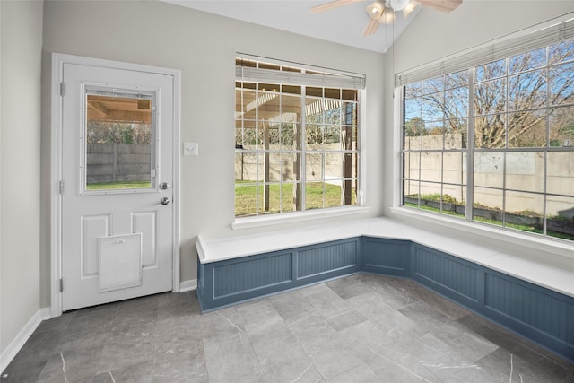 unfurnished sunroom featuring vaulted ceiling and ceiling fan