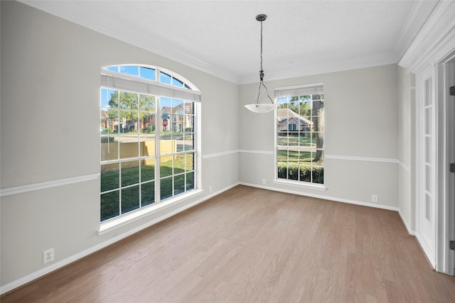 unfurnished dining area with hardwood / wood-style floors and crown molding