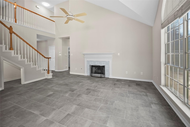 unfurnished living room featuring ceiling fan, a fireplace, and high vaulted ceiling