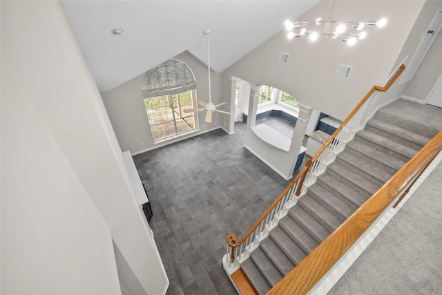 staircase featuring carpet, high vaulted ceiling, and a notable chandelier