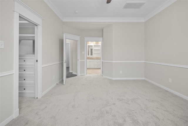 unfurnished room featuring light colored carpet and ornamental molding