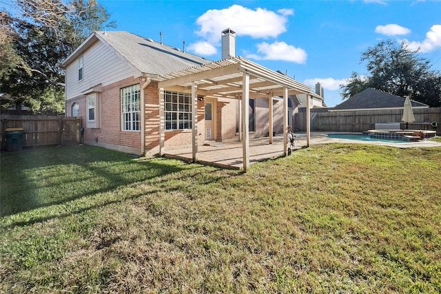 back of house with a pergola, a patio area, a yard, and a fenced in pool