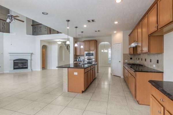 kitchen featuring stainless steel appliances, a kitchen island with sink, ceiling fan, pendant lighting, and light tile patterned floors