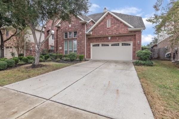 front of property with a garage and a front yard