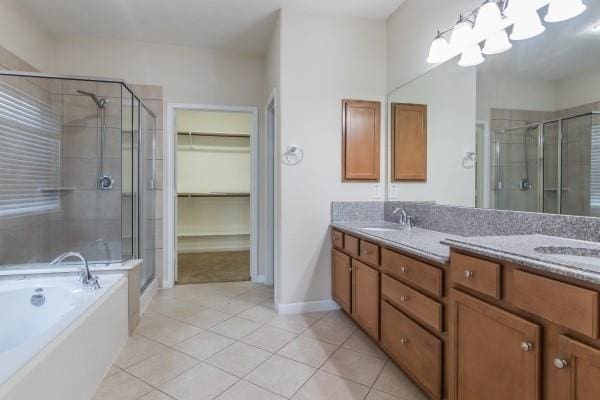 bathroom with tile patterned floors, separate shower and tub, and vanity