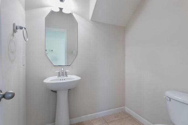 bathroom with tile patterned floors and toilet