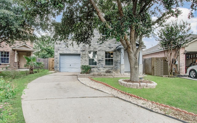 view of front of home with a front yard and a garage