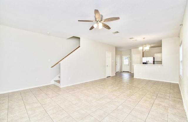 unfurnished living room featuring ceiling fan with notable chandelier and light tile patterned flooring