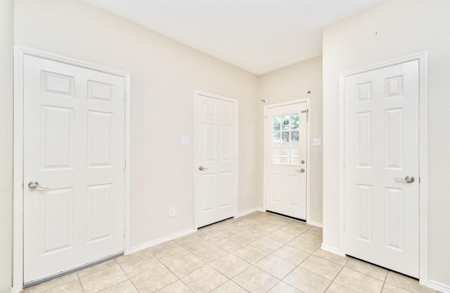 foyer entrance with light tile patterned flooring