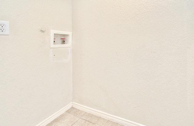 washroom featuring washer hookup and light tile patterned flooring