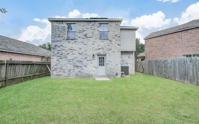 back of house featuring central AC and a lawn