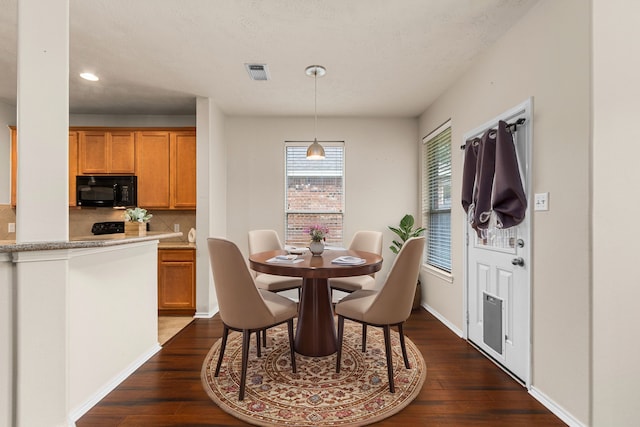 dining room with dark hardwood / wood-style flooring