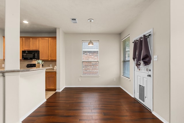 kitchen featuring pendant lighting, decorative backsplash, and dark hardwood / wood-style flooring