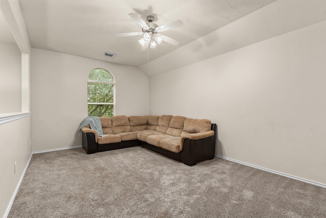 carpeted living room with ceiling fan and vaulted ceiling