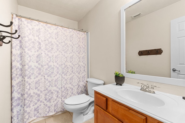 bathroom featuring tile patterned floors, vanity, and toilet