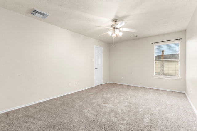 empty room with carpet flooring and ceiling fan