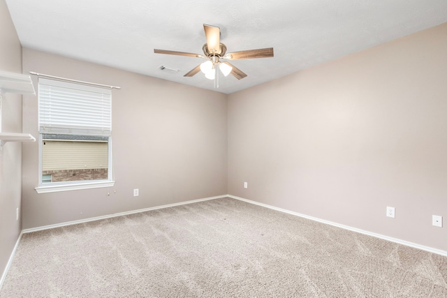 empty room with ceiling fan and carpet floors