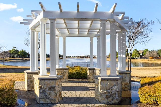 view of patio with a water view and a pergola