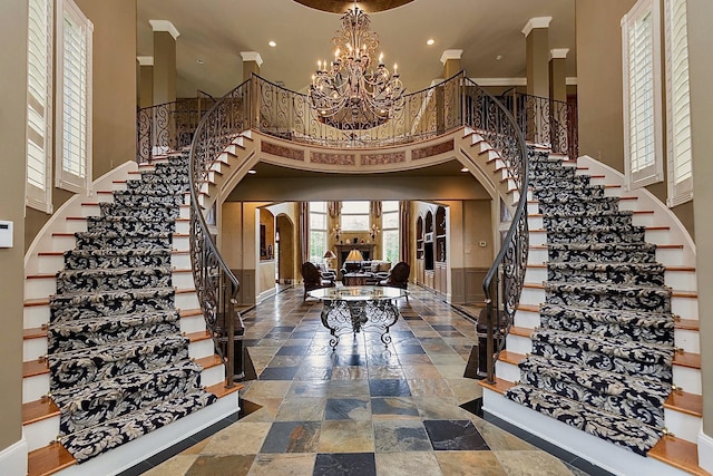 foyer entrance featuring a chandelier and a high ceiling