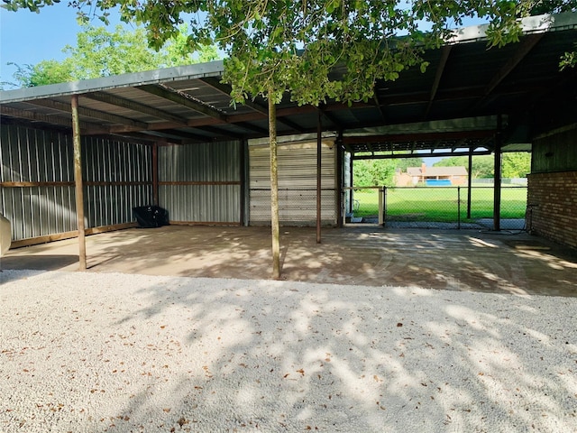 view of parking / parking lot featuring a carport