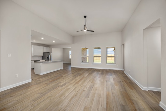 unfurnished living room with ceiling fan and light hardwood / wood-style floors